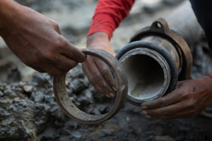 A labourer fixes a DI joint in of a 100mm Ductile Iron (DI) pipe line to avoid any leaks in Azizabad village in Palwal, Haryana. The Jal Jeevan Mission (JJM), is envisioned to provide safe and adequate drinking water through individual household tap connections by 2024 to all households in rural India. The programme will also implement source sustainability measures as mandatory elements, such as recharge and reuse through grey water management, water conservation, rain water harvesting.